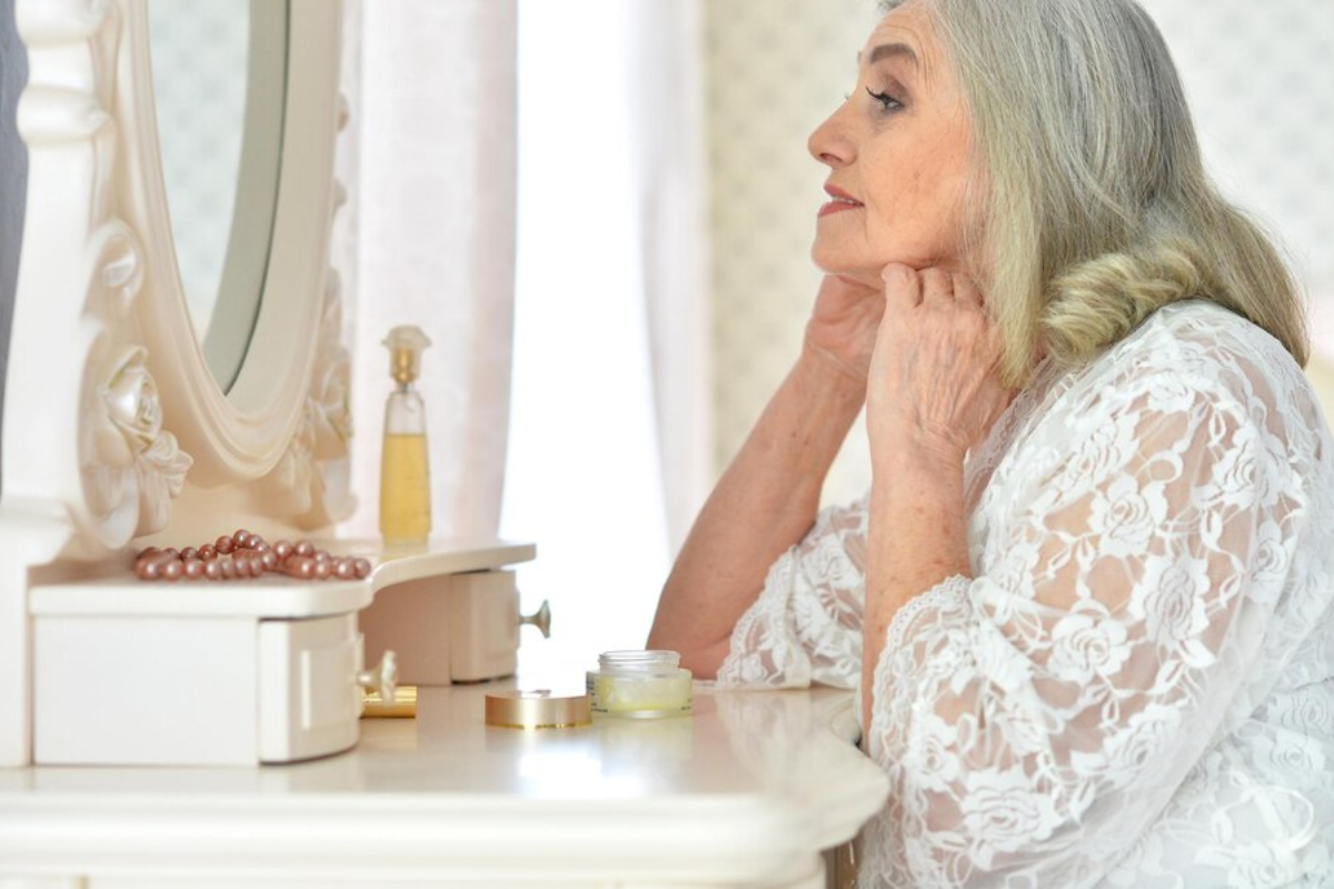 mature woman applying her makeup